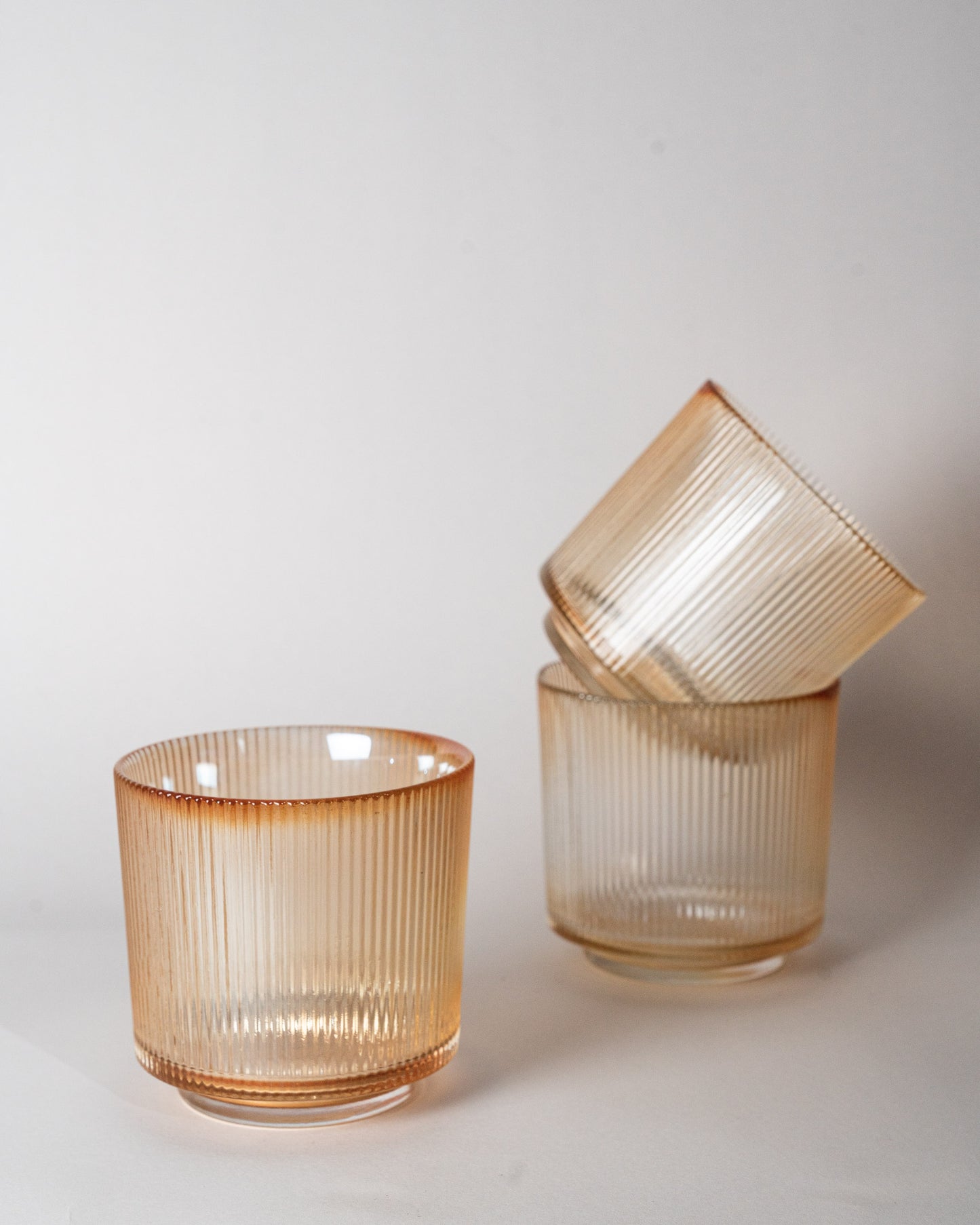 Three glass holder in cream studio shot.