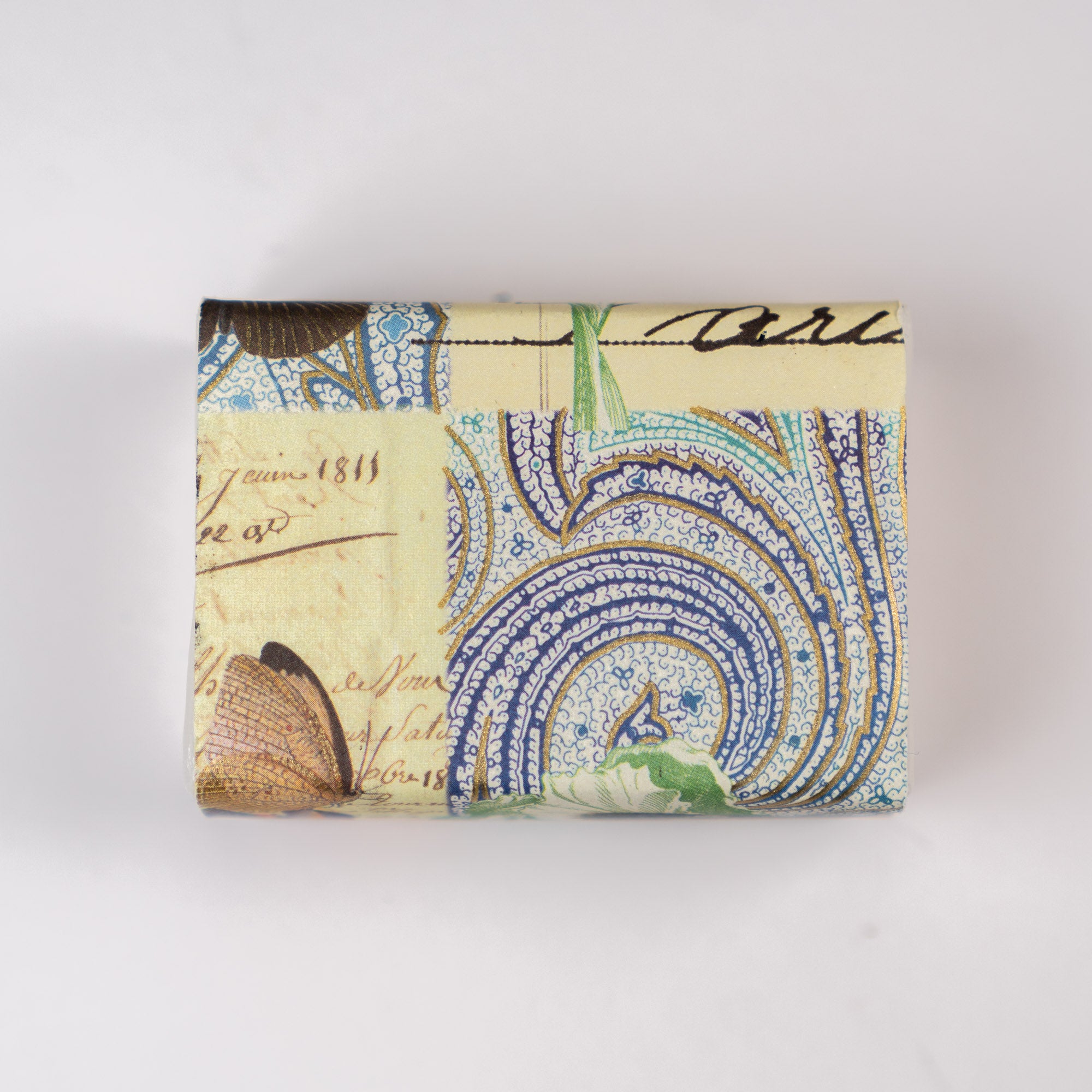 Soap bar with paisley and botanical design on a white background