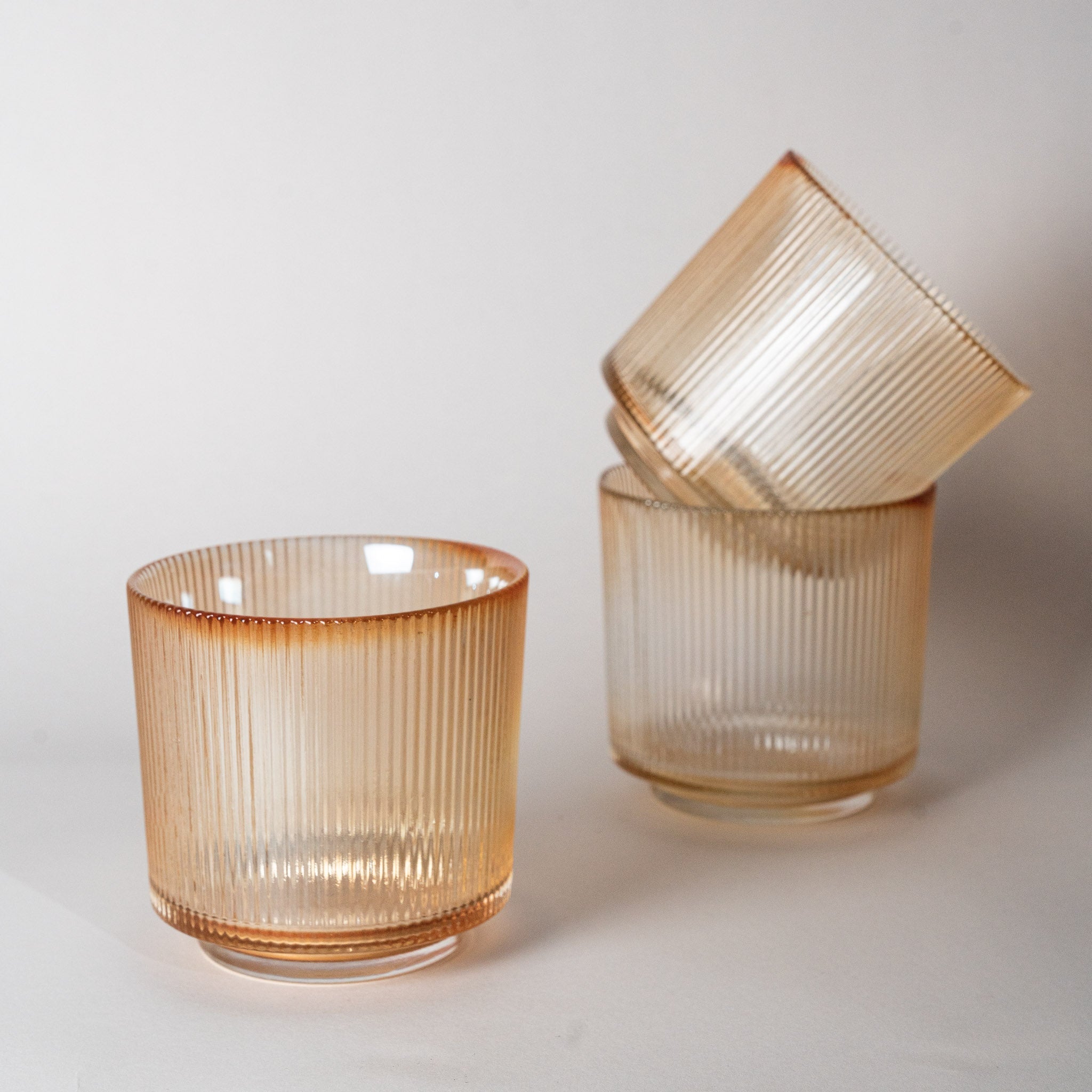 Three glass holder in cream studio shot.