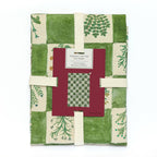 A green and white checkered organic cotton tea towel with herb botanical llustrations. The tea towel is wrapped ready for gifting.