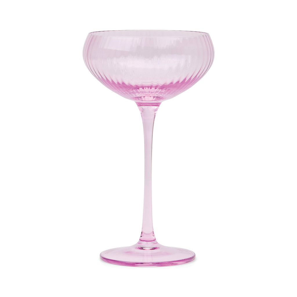 Lilac coupe glass with a long stem on a white background