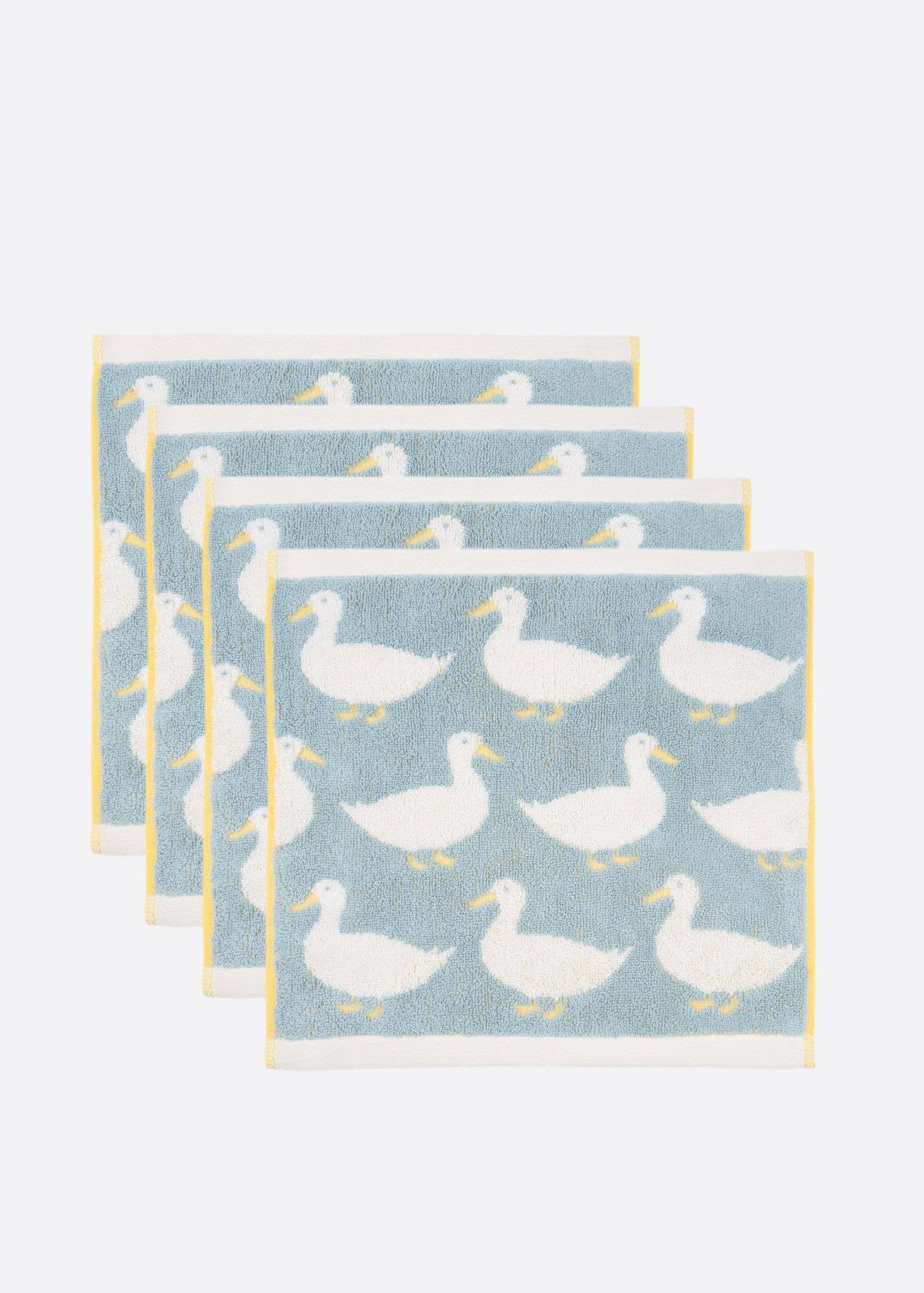 Set of four pale blue face cloths with white duck patterns on a white background