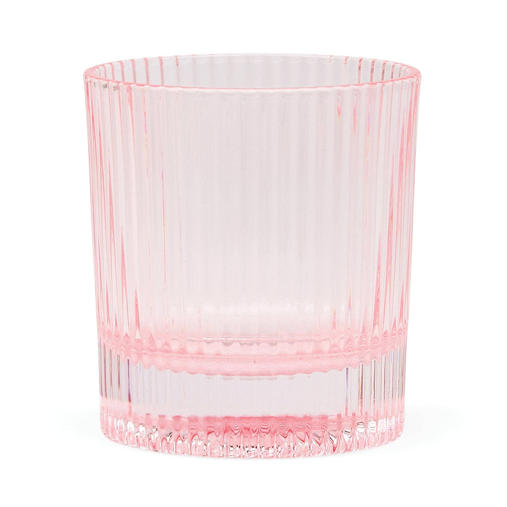 Pink glass tumbler on a white background. glass is Scout Lowball by Here's How.