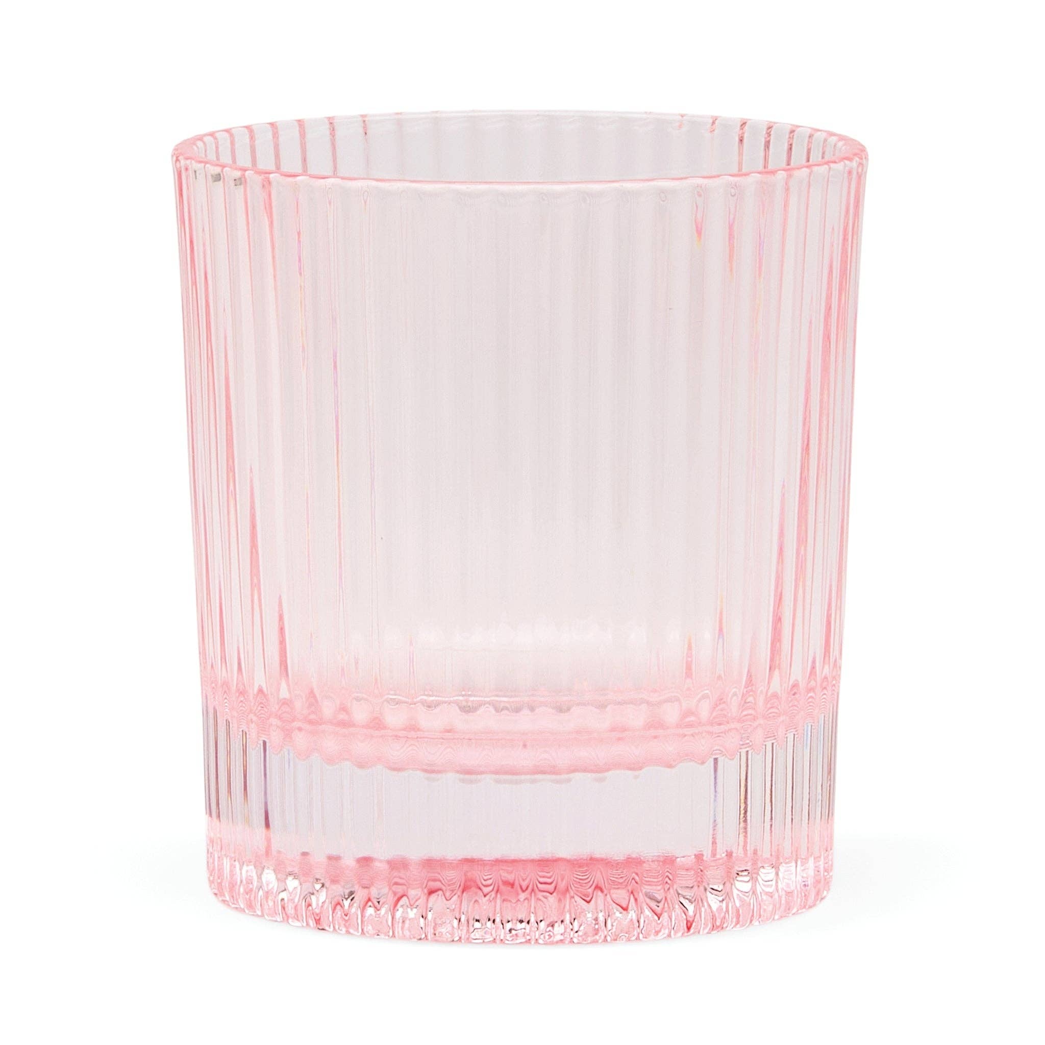 Pink glass tumbler on a white background. glass is Scout Lowball by Here's How.