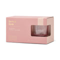 Pink packaging box with a clear glass lowball glass inside on a white background