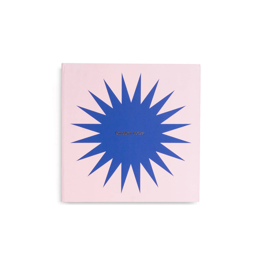 Notebook with blue starburst design on a pink cover