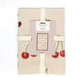 100% organic cotton tea towel with cherry design, packaged with a fabric ribbon and includes a hanging loop.