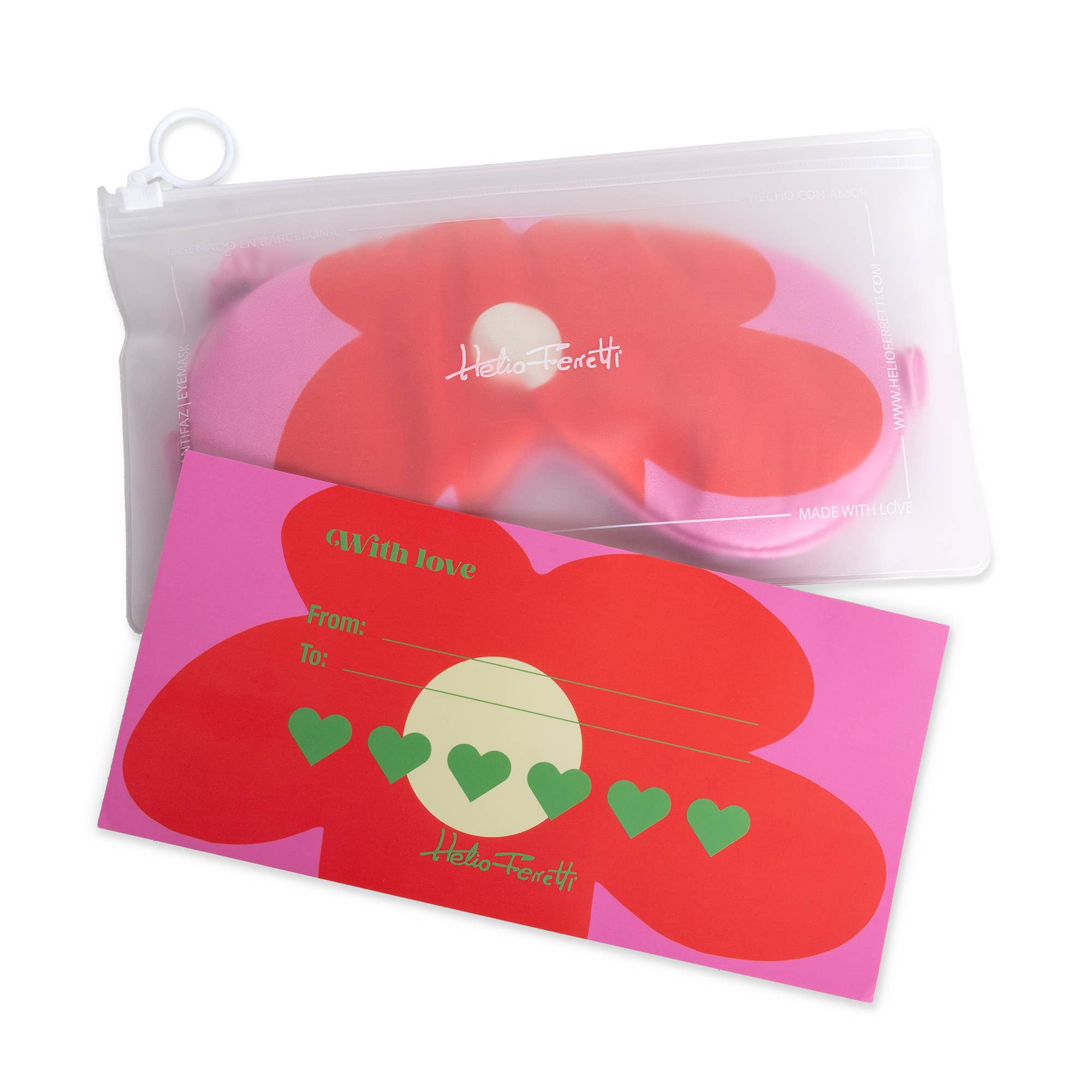Red flower-shaped card with green hearts and a  pouch with on a pink and red sleep mask inside it.