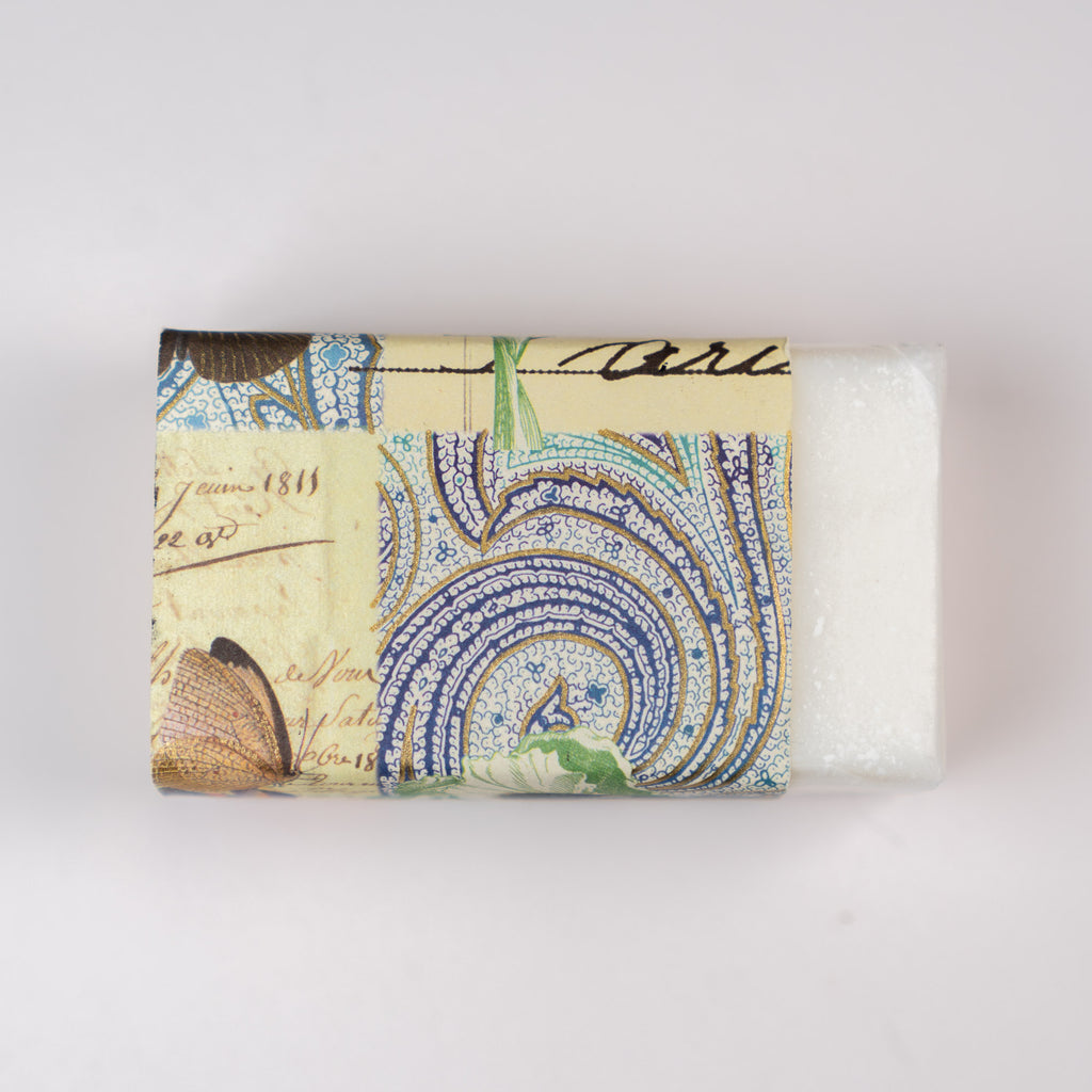 Soap bar with decorative packaging featuring a vintage design on a white background