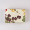 Rectangular soap with botanical illustration featuring berries and leaves on a white background.