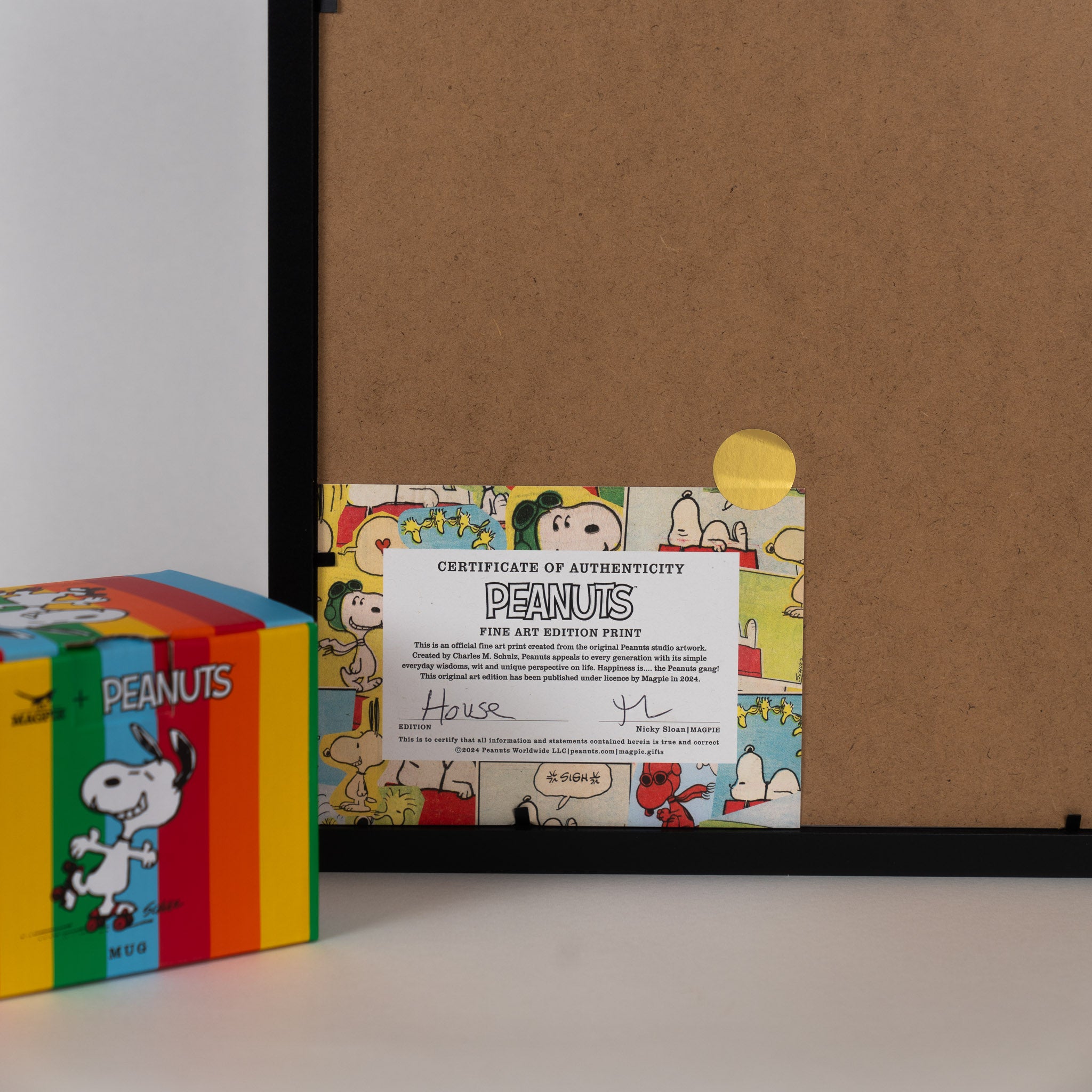 Gift boxed mug and back of  framed snoopy picture showing authentication certificate