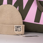 Close up of jumbo bag and cream Wild Swim hat. Great gift for wild swimmers from The Cornish Studio.