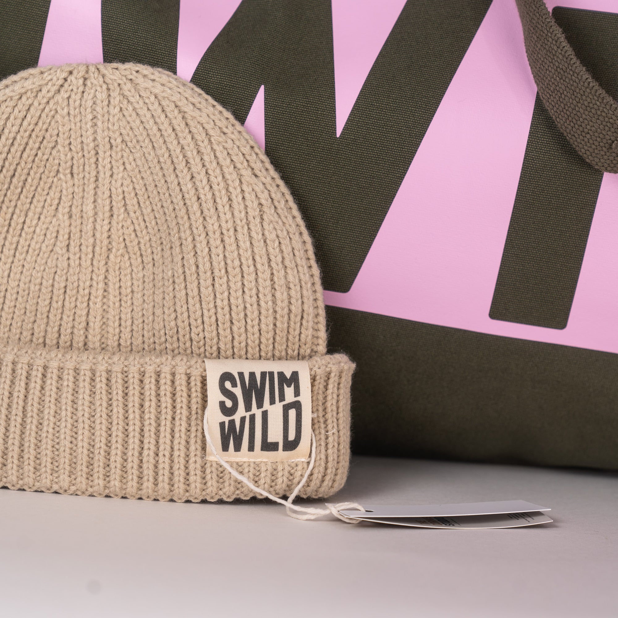 Close up of jumbo bag and cream Wild Swim hat. Great gift for wild swimmers from The Cornish Studio.