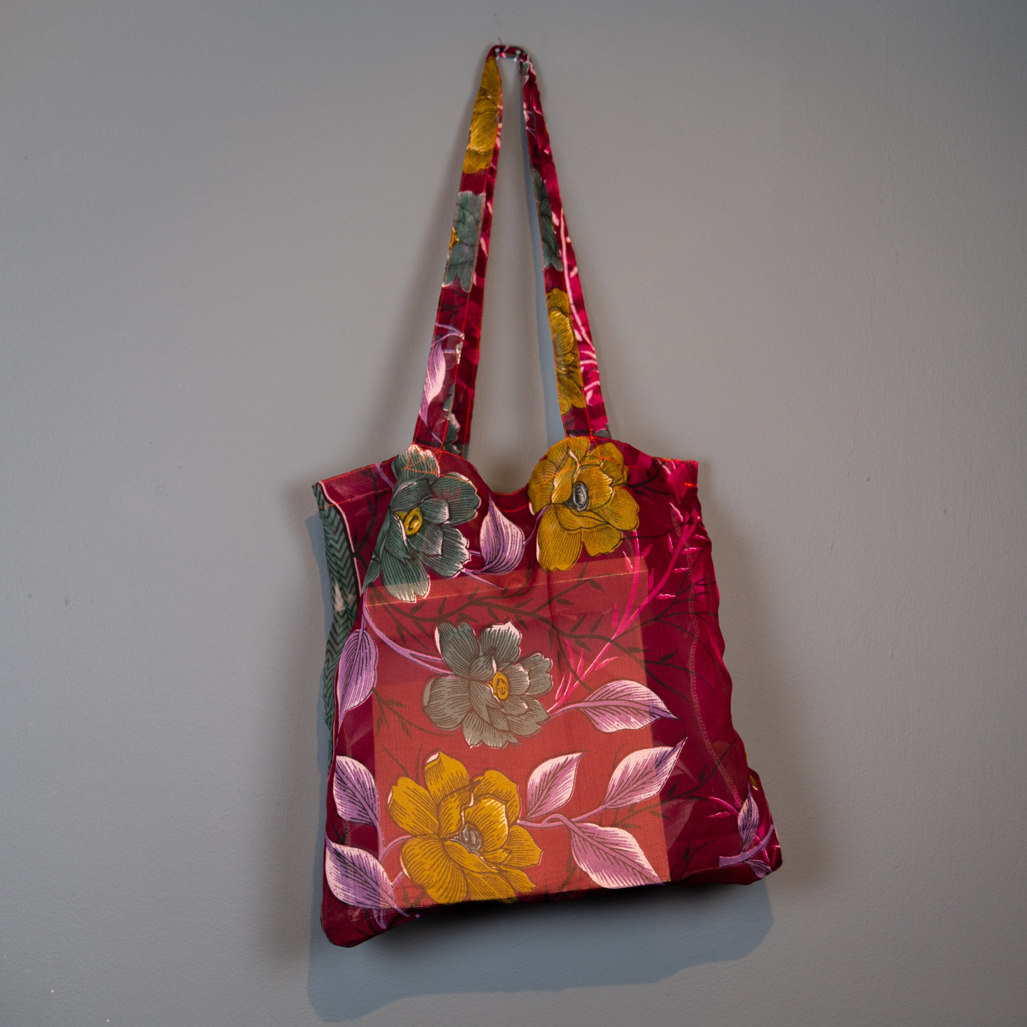 Dark red multi coloured shopper.