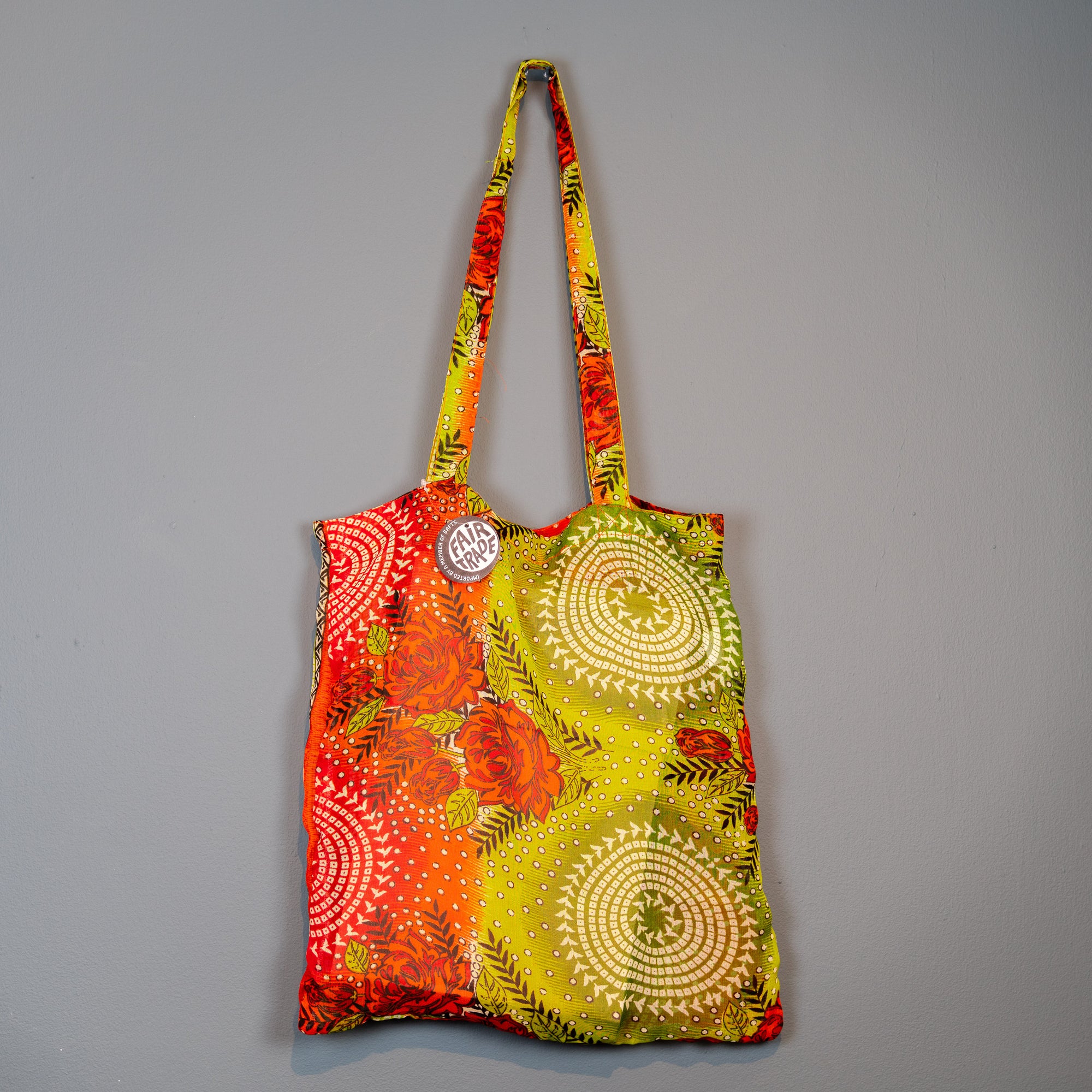 Fairtrade lime and orange shopping bag. Showing Fairtrade label