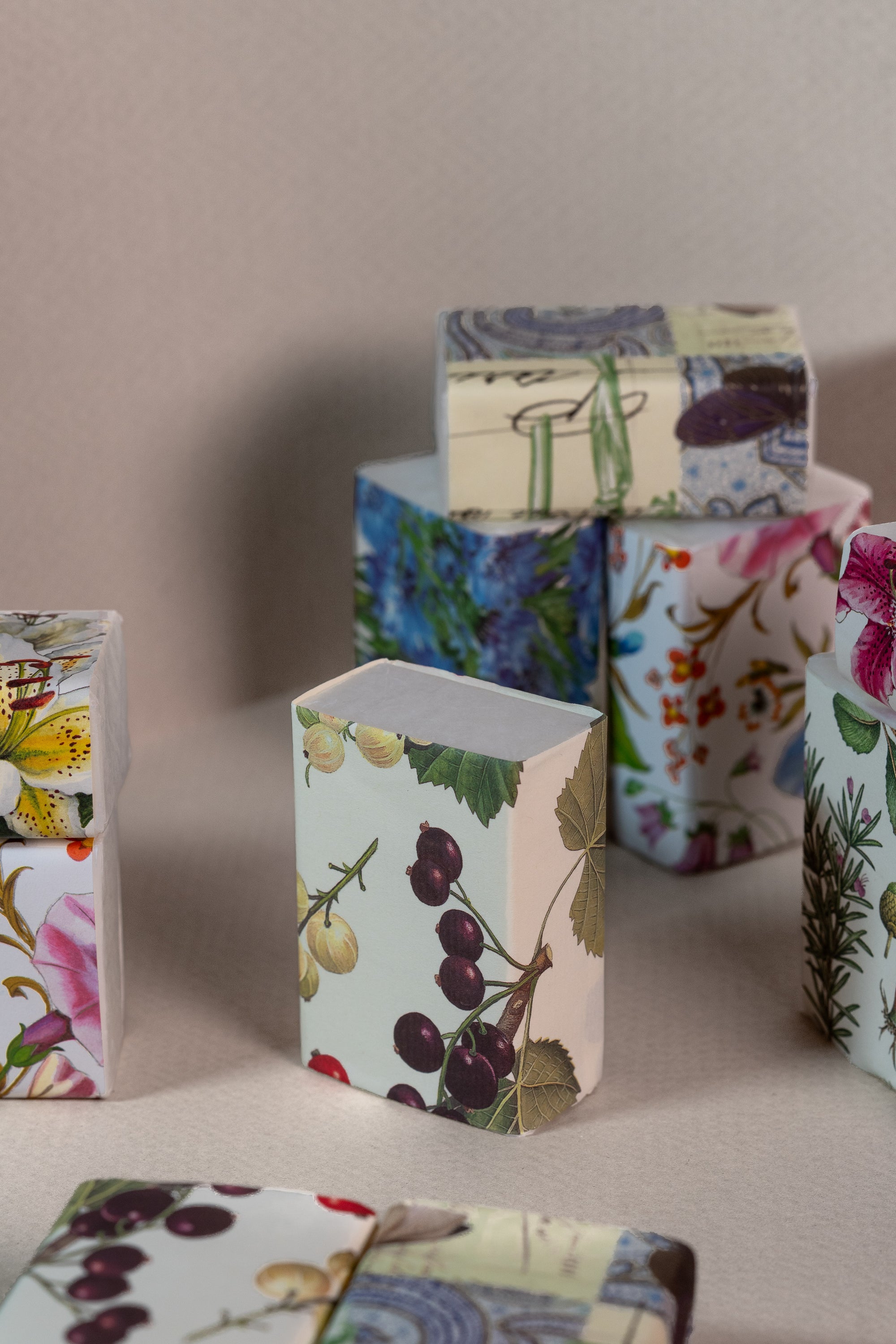 Collection of soaps with floral wrapping- studio shot with a cream background.