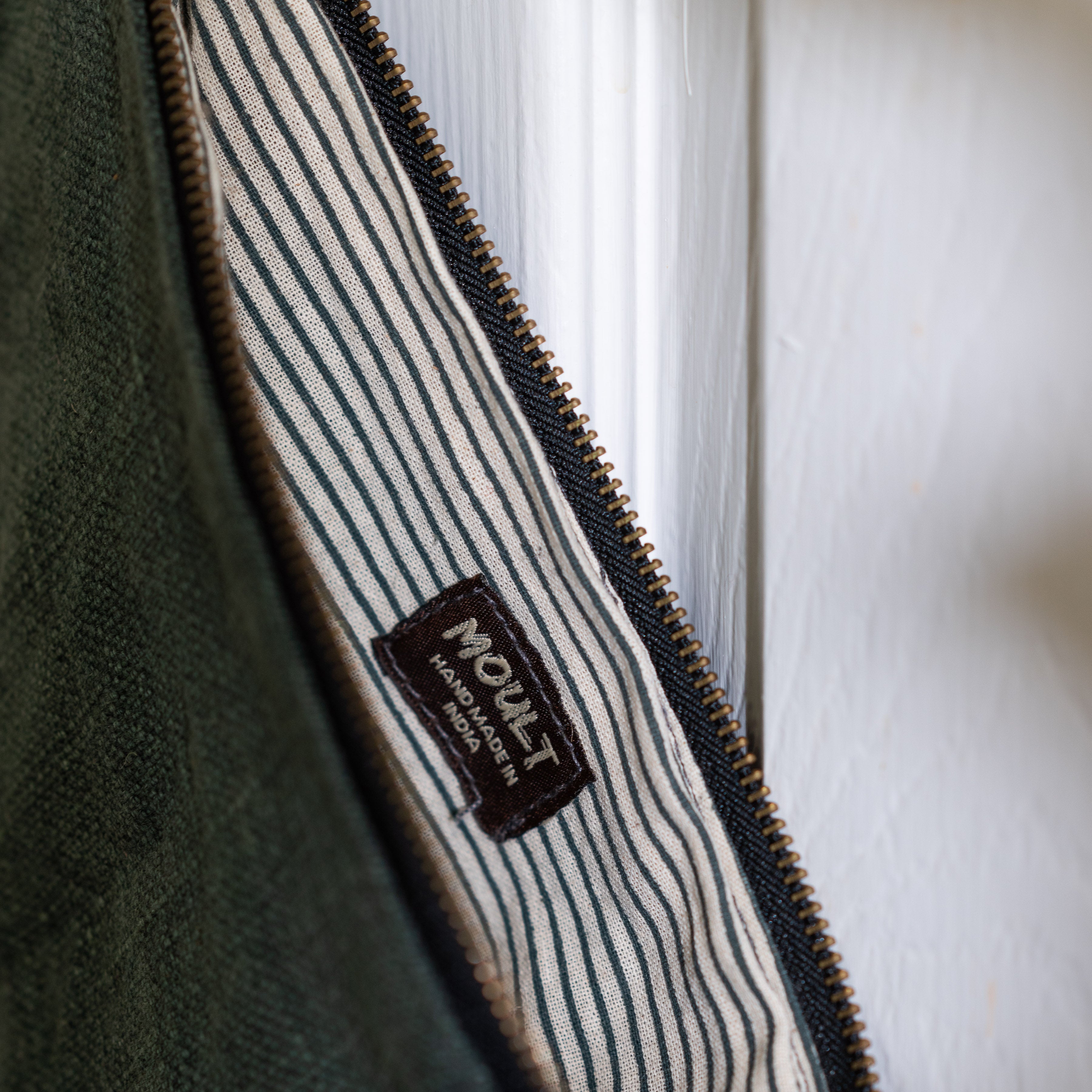 Detail inside grey bag - striped inner with label text is " MOULT HANDMADe IN INDIA"