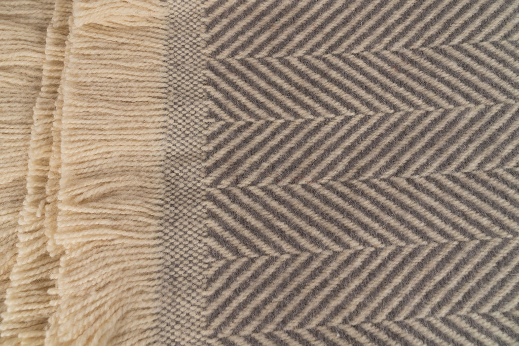 Close up of Tweedmill Textiles .Silver birch blanket with cream firinge. 100% recycled wool.