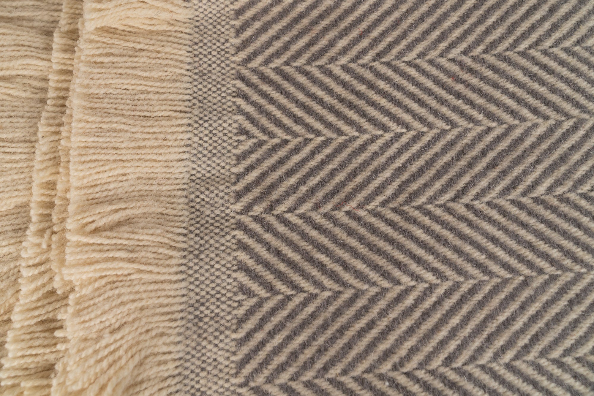 Close up of Tweedmill Textiles .Silver birch blanket with cream firinge. 100% recycled wool.