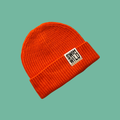 Orange cosy fisherman style beanie hat on aqua background. Text on hat reads SWIM WILD. Great sustainable gift for Wild Swimmers