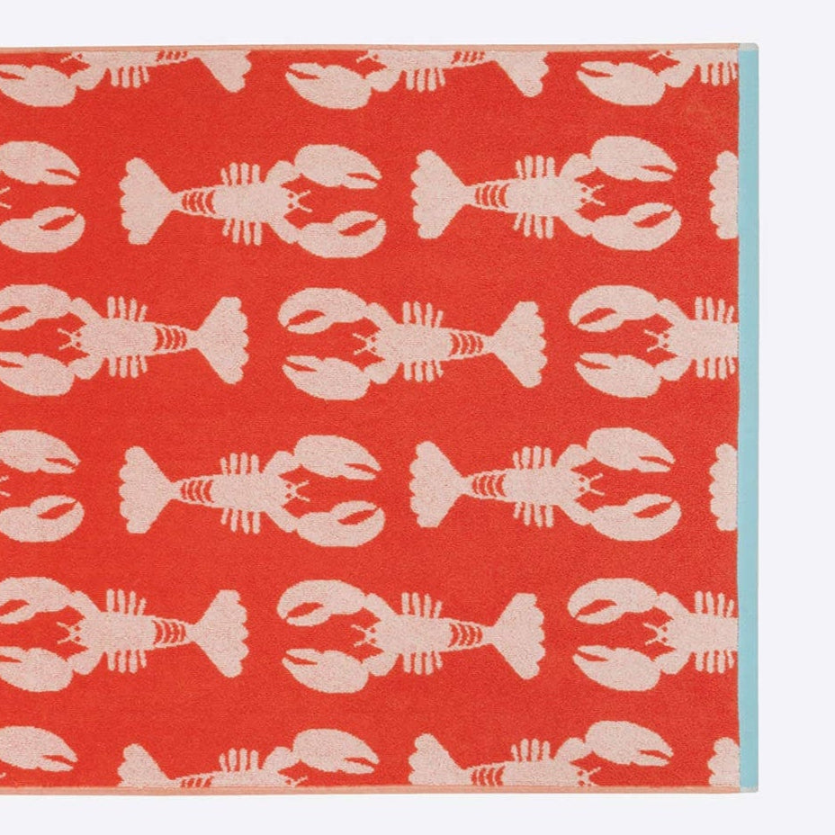 Towel with lobster pattern on a red background