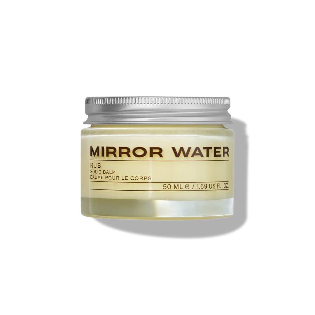 Glass jar with silver lid of sealed cream coloured product called 'Mirror Water" A body RUB balm in 50ml size.