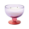 Paddywax Aura Pepper and Plum Candle in a glass holder with a gradient color from purple to pink on a white background.