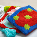 Colorful blue beaded clutch bag/pouch with green star patterns on a a red oval shape.