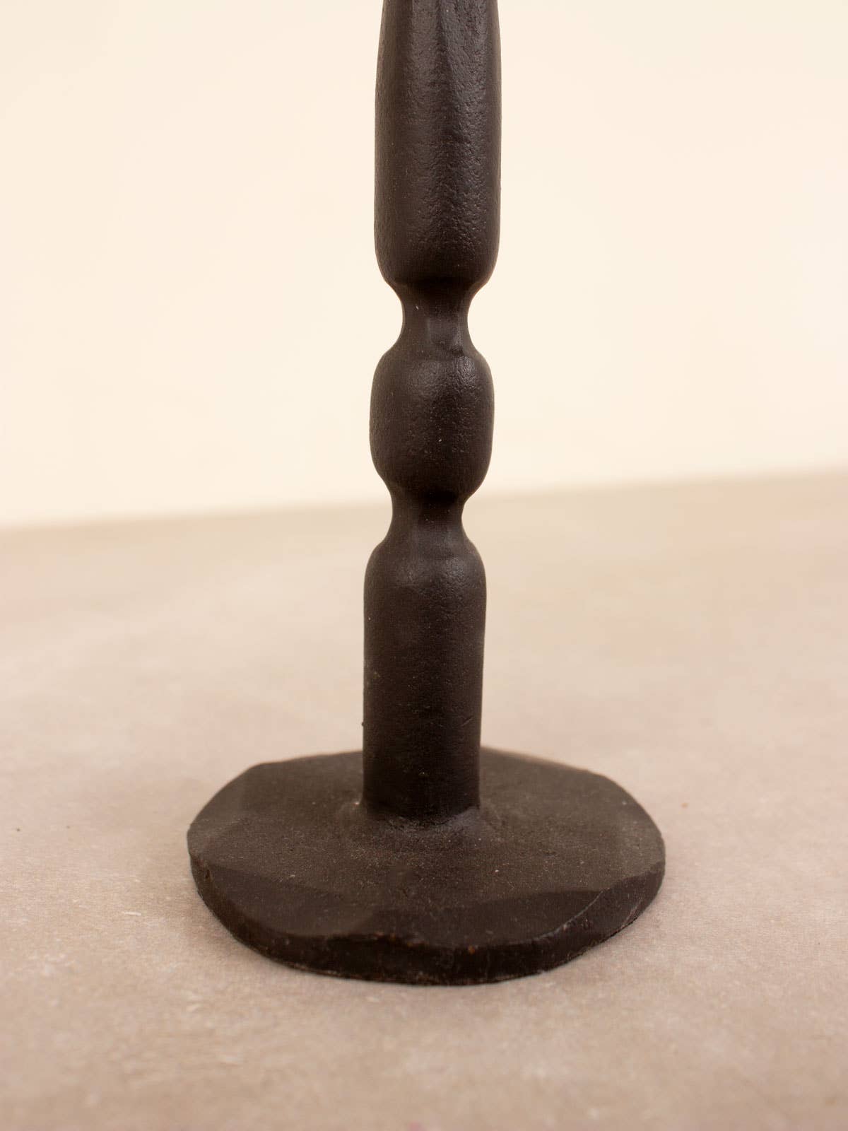 Close up of candlestick base. Unique hand forged tall candlestick.