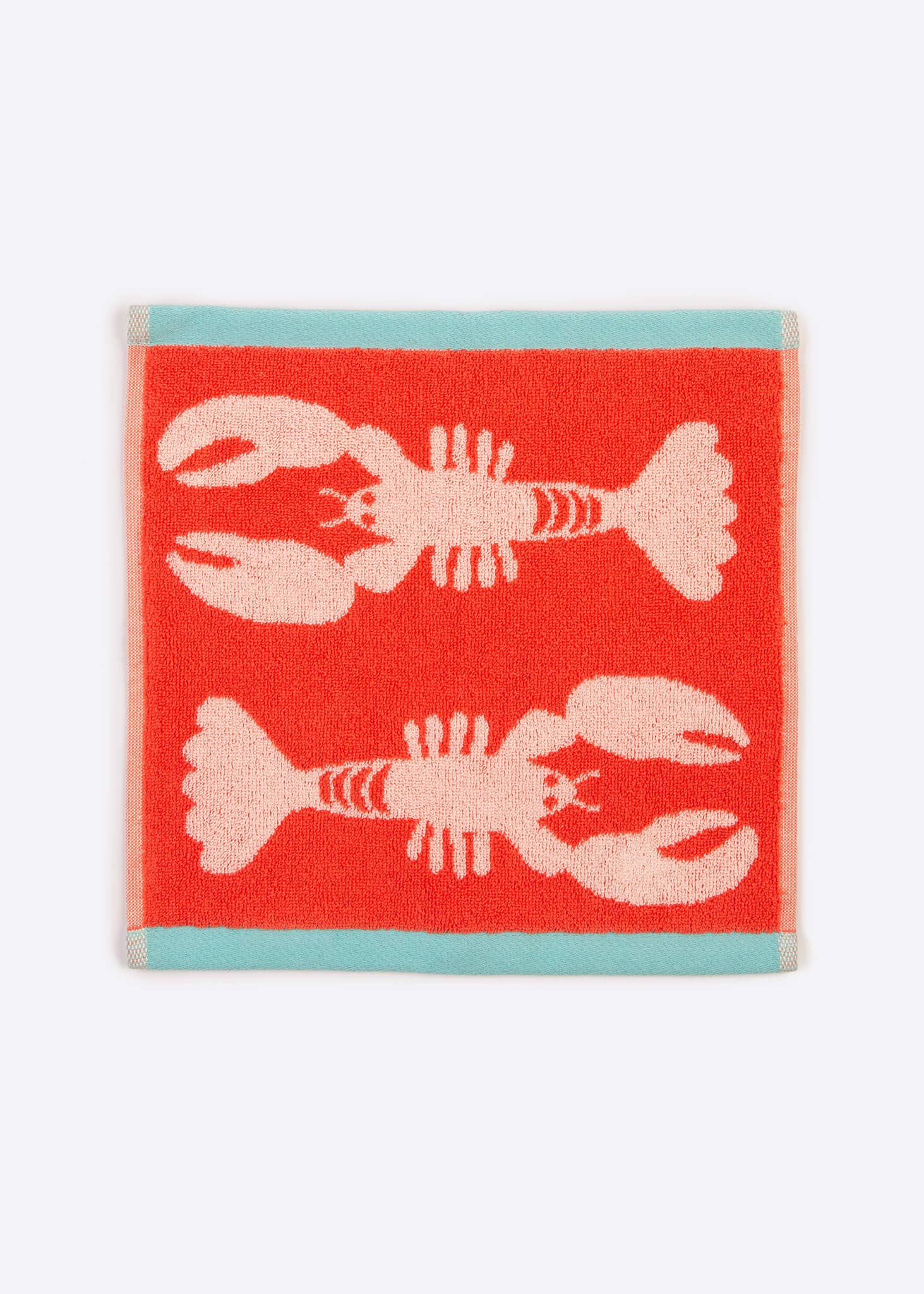 Coral face cloth with pink lobster design on a white background. 100% organic cotton. Great gift under £10