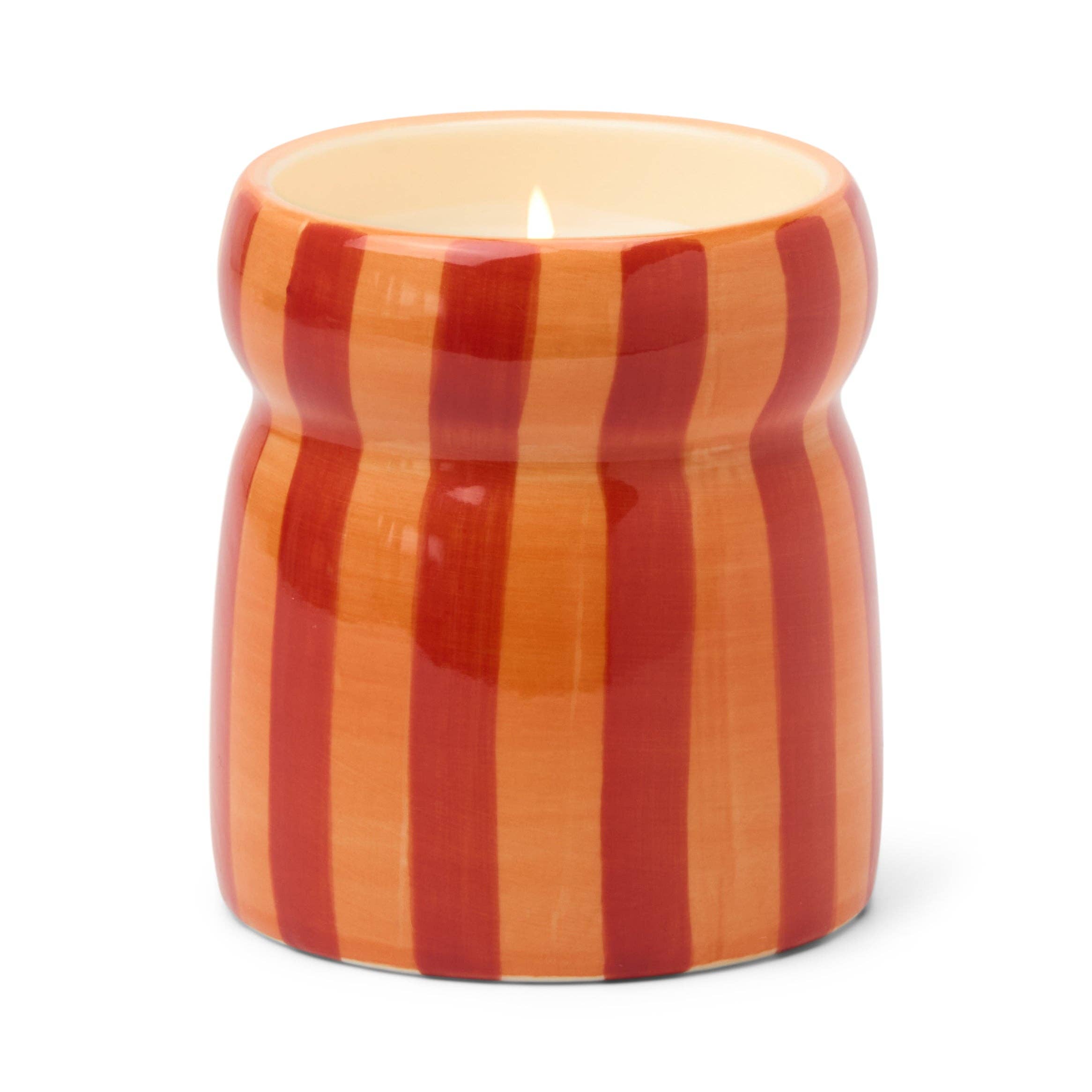 Paddywax candle in a striped orange and red container on a white background