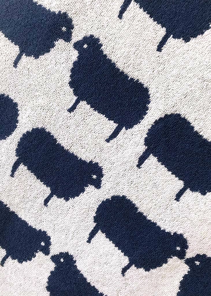 Pattern of dark blue sheep silhouettes on a light white background