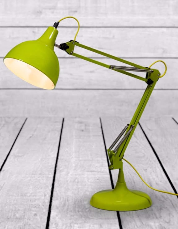 Lime green adjustable desk lamp on a light wooden floor.