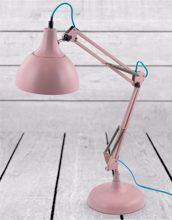 Pink desk lamp on a light wooden surface